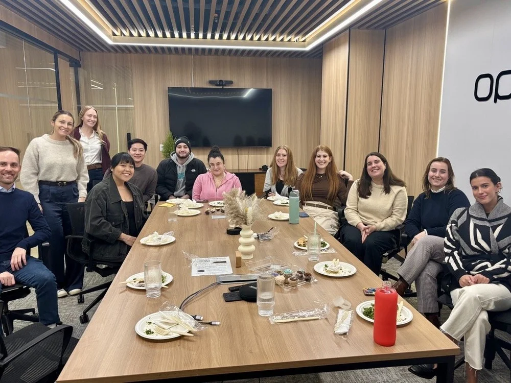 OpAD Media employees seated together during a team member celebration lunch