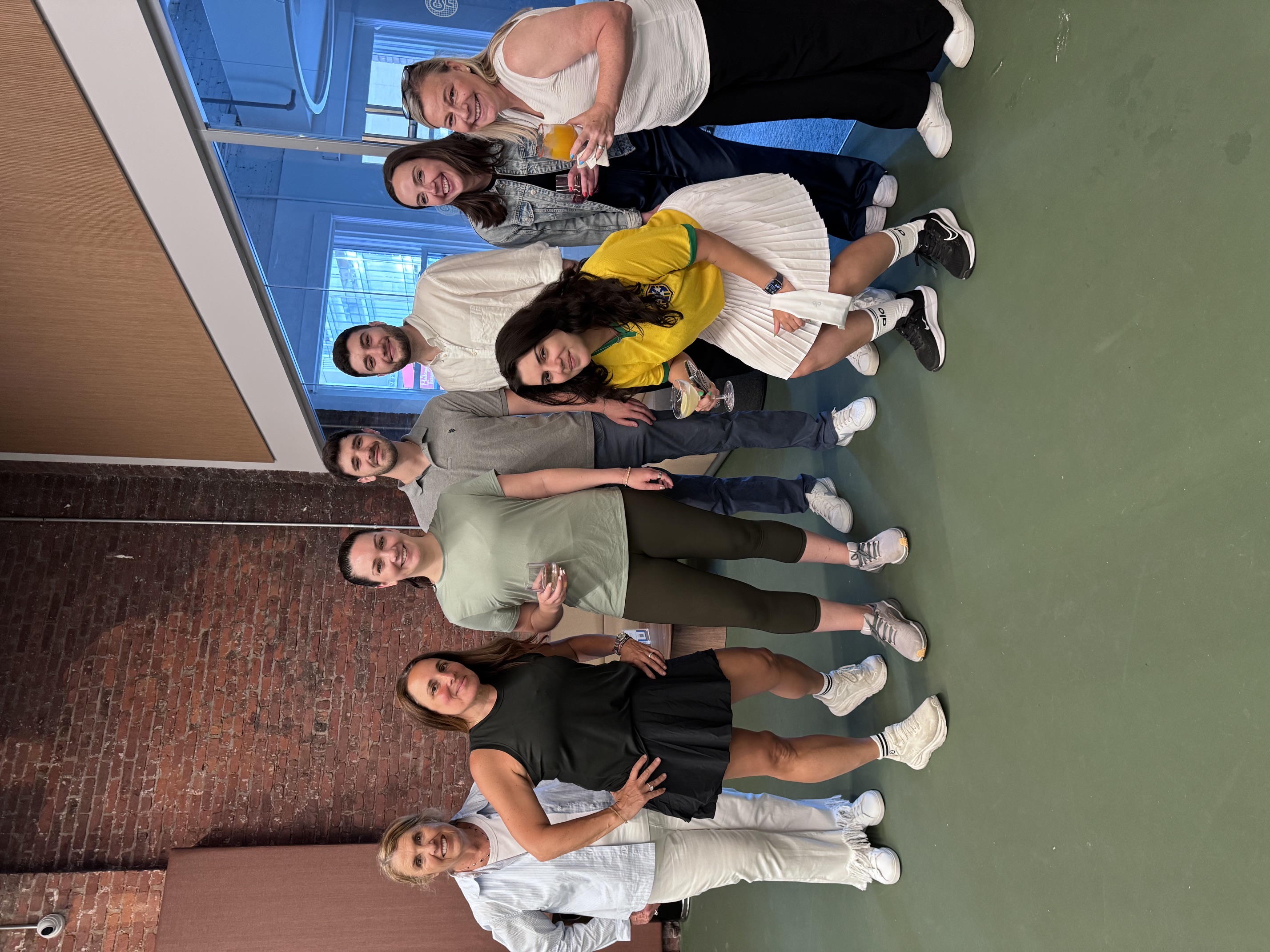 OpAD Media team gathered for a company culture and team-building event playing pickleball, being competitive, having food and drinks, at City Pickle Times Square