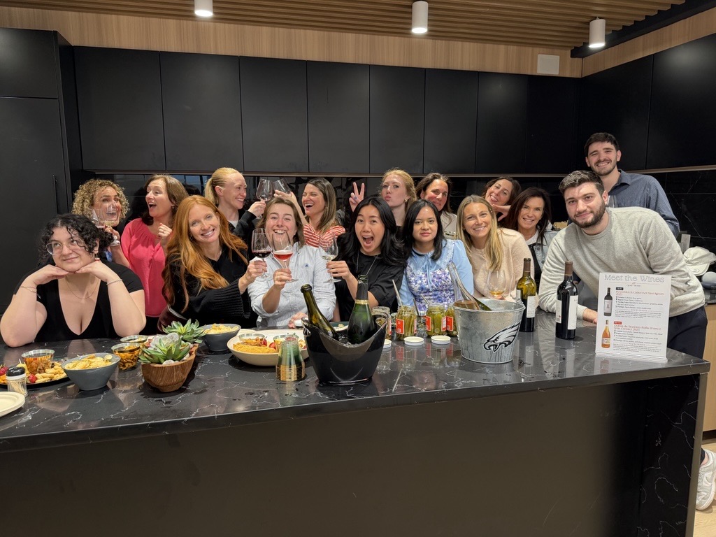 OpAD Media team members celebrating team culture together at a company wine tasting event